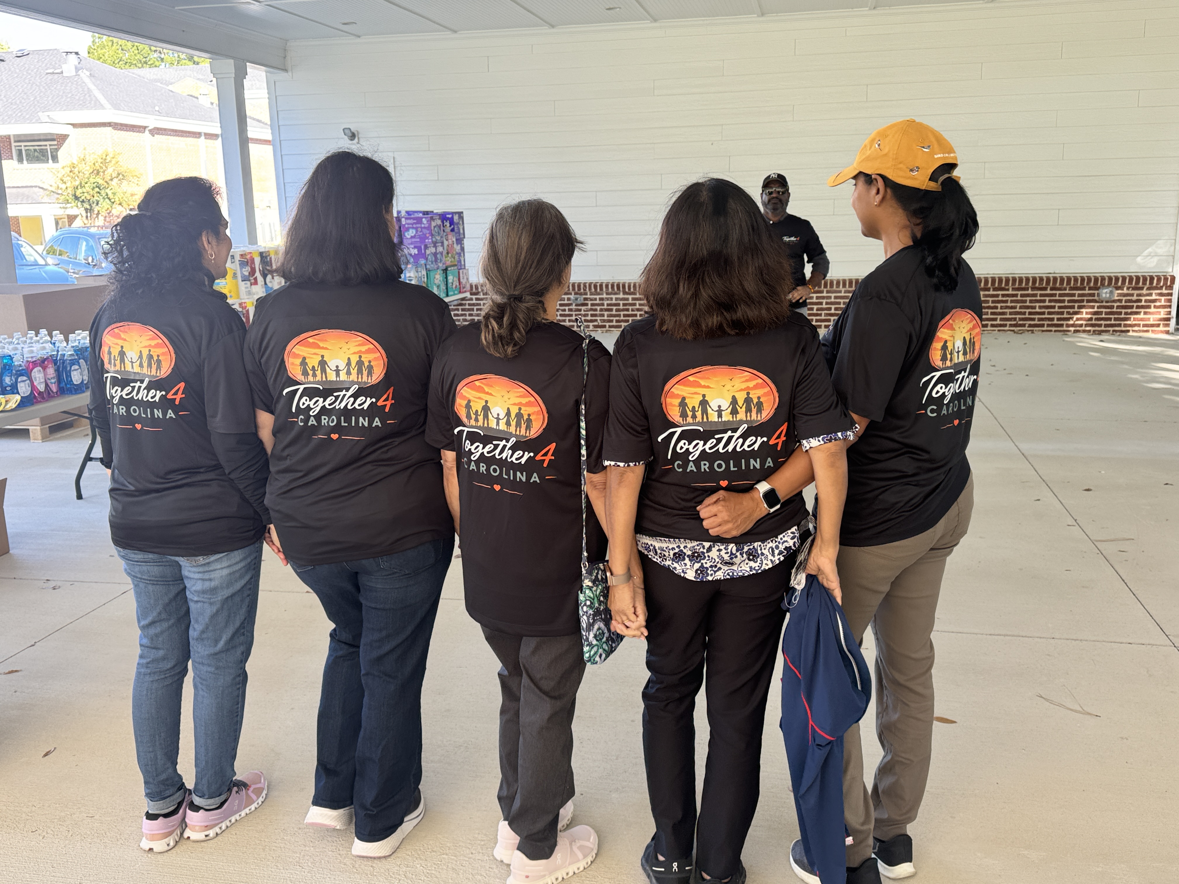 Together 4 Carolina volunteers wearing matching shirts at the Zebulon community pantry